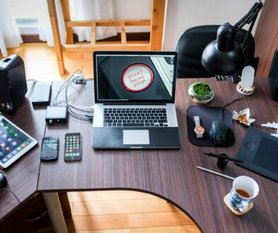 A contemporary office desk setup with laptops, gadgets, and accessories, creating a tech-savvy workplace.