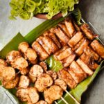 Appetizing Filipino street food served on banana leaves, capturing authentic flavors. Perfect for food lovers.
