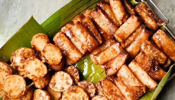 Appetizing Filipino street food served on banana leaves, capturing authentic flavors. Perfect for food lovers.