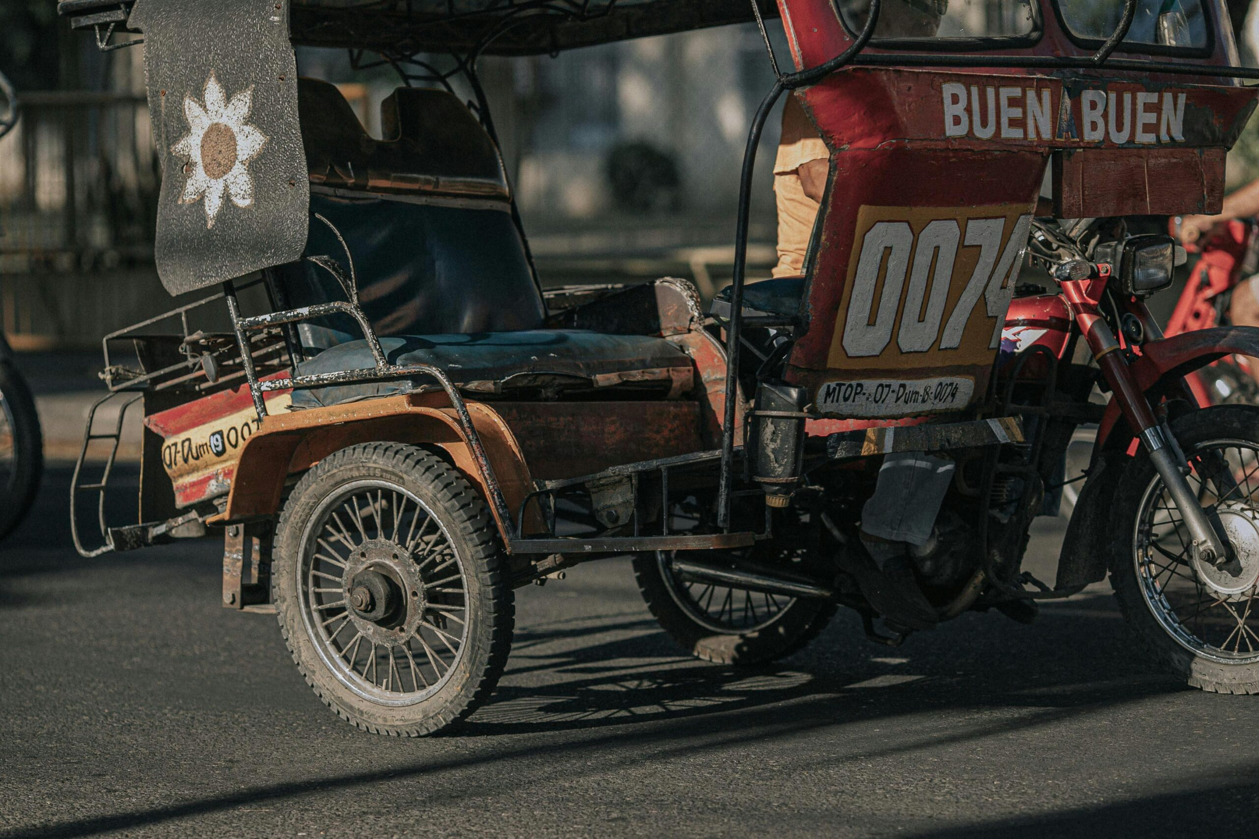 A colorful tricycle parked on a street in Negros Island Region, showcasing Filipino culture.